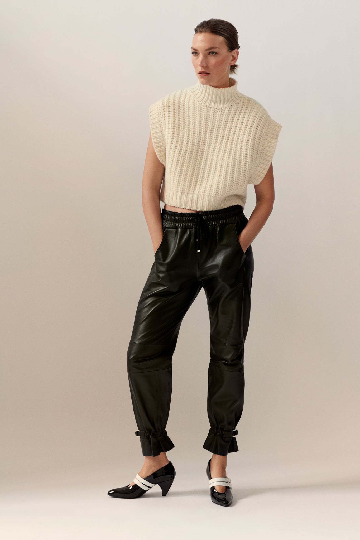 Arizona Muse in the Roe SKIIM Paris ethical knit sweater vest and leather jogger pants